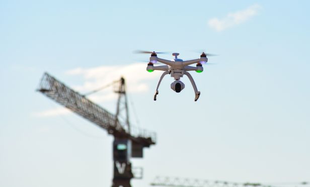 Drone flying near a construction crane.