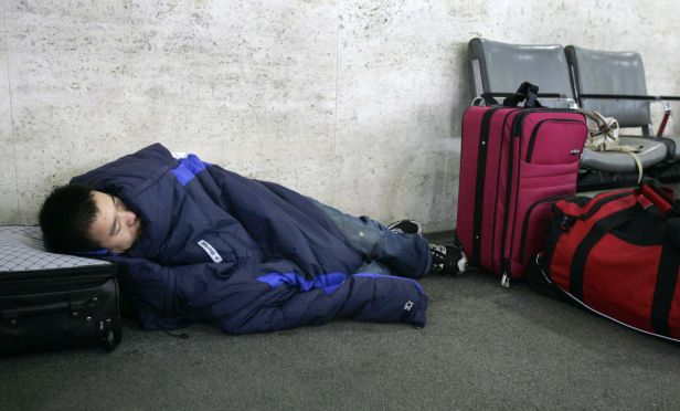 Stranded traveler sleeping in airport
