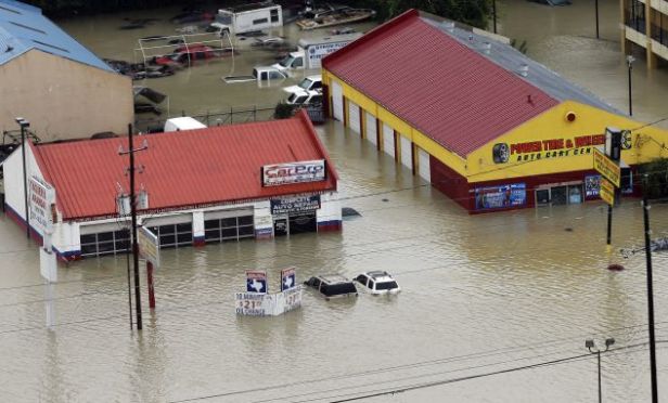 Businesses and cars are flooded.