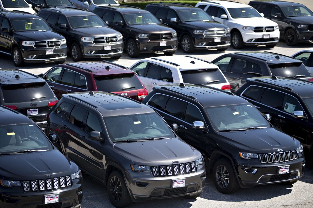 Jeep and Dodge vehicles at a Fiat Chrysler car dealership.