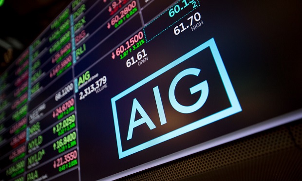 A monitor displays American International Group Inc. (AIG) signage on the floor of the New York Stock Exchange (NYSE) in New York, U.S., on Friday, February 9, 2018. (Photo: Michael Nagle/Bloomberg)