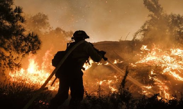 A firefighter battles the Holy Fire burning in the Cleveland National Forest along a hillside at Temescal Valley in Corona, Calif., Thursday, Aug. 9, 2018. (Photo: Ringo H.W. Chiu/AP)