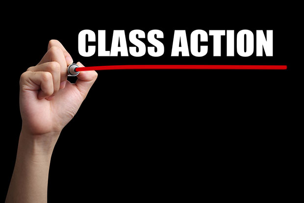 Hand writing class action on blackboard red underline 
