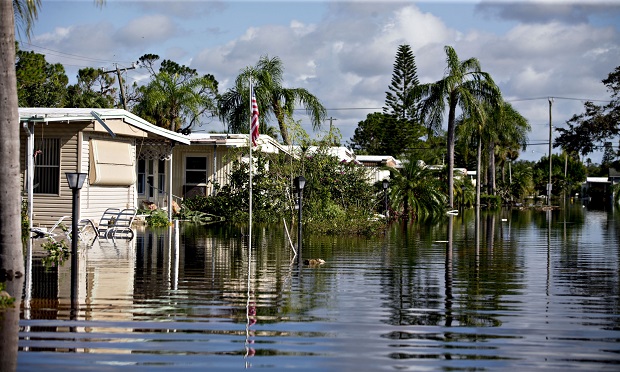 Mobile homes stand in a flooded neighborhood in Bonita Springs, Florida, U.S., on Tuesday, Sept. 12, 2017. Hurricane Irma smashed into Southern Florida as a Category 4 storm, driving a wall of water and violent winds ashore and marking the first time since 1964 the U.S. was hit by back-to-back major hurricanes. (Photo: Daniel Acker/Bloomberg)