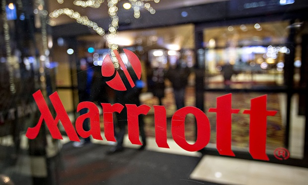 A logo is displayed on an entry door to a Marriott International hotel in Chicago, Illinois, U.S., on Friday, Nov. 30, 2018. A cyber breach in Starwood's reservation system had allowed unauthorized access to information about as many as 500 million guests since 2014. (Photo: Daniel Acker/Bloomberg)