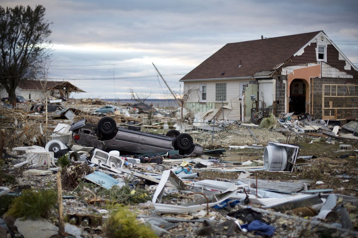 An overturned car sits amidst debris from houses destroyed during Hurricane Sandy in Union Beach, New Jersey, U.S. on Saturday, Nov. 3, 2012. (Photo: Victor J. Blue/Bloomberg)