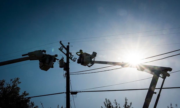 Workers for Source Power Services, contracted by Pacific Gas & Electric (PG&E), repair a power transformer in Healdsburg, California, U.S., on Thursday, Oct. 31, 2019. While the extreme winds were forecast to ease, wildfire risks will remain high through Friday, according to the U.S. Storm Prediction Center. Photographer: David Paul Morris/Bloomberg