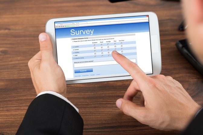 Man's-hands-tablet-taking-survey