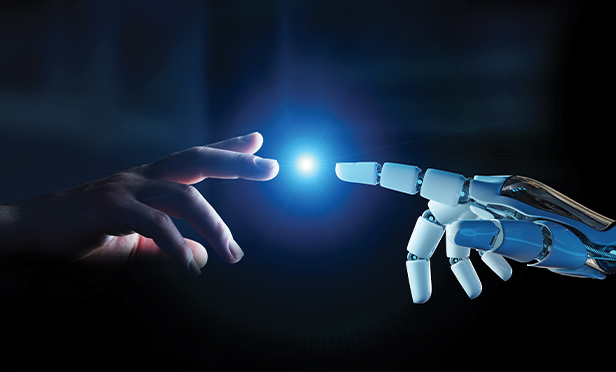 The index finger of a human hand touches the index finger of a robot.