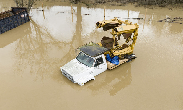 Floodwaters from the overflowing Salinas River washed over a truck during rain storms in California in January 2023. (Josh Edelson/Bloomberg)