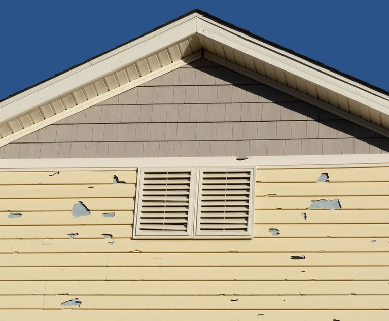 Hail damage in siding on the side of a home.