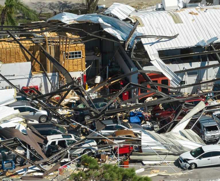 Understanding and analyzing extreme weather-related patterns that impact policyholders is critical for insurance carriers to make informed decisions. Here, damaged vehicles comingle with the remains of an industrial building in the wake of Hurricane Ian. (Credit: bilanol/Adobe Stock)