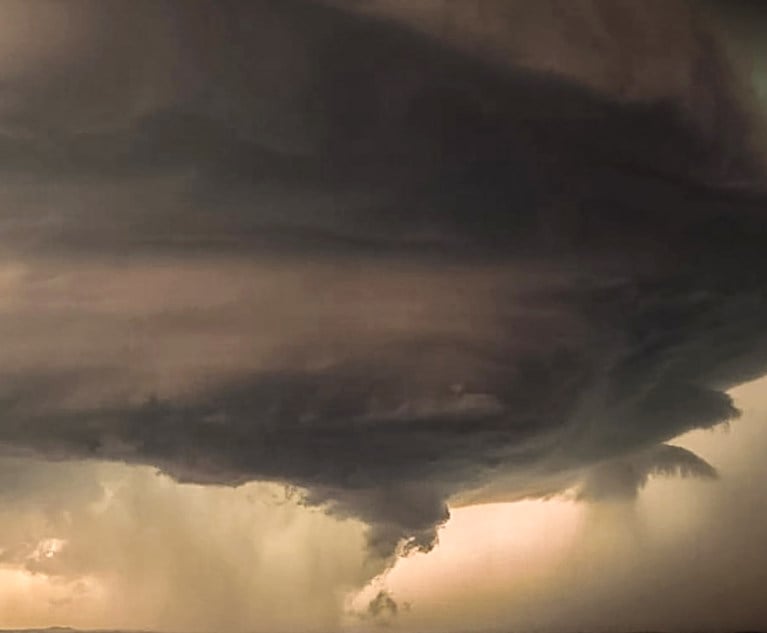 A photo of a tornado over a landscape
