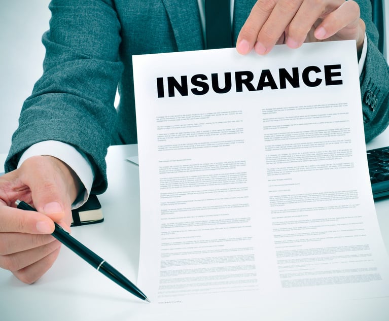 a young man in suit in his office showing an insurance policy and pointing with a pen where the policyholder must to sign. Credit: nito/Adobe Stock