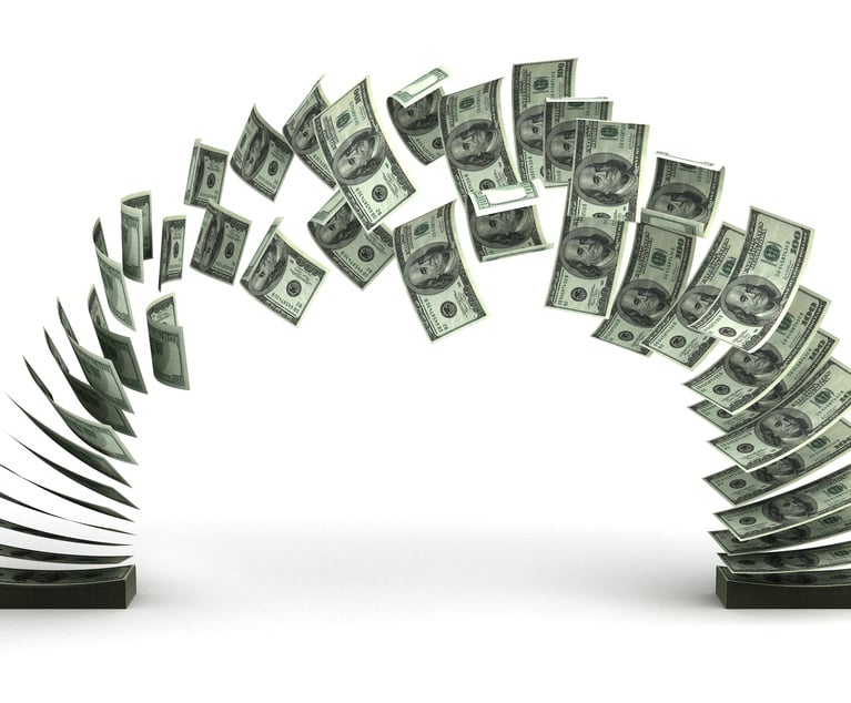 Cash being transferred from one place to another. Credit: selensergen/Adobe Stock.