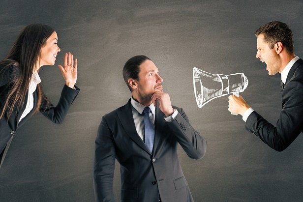 Businessman between man with megaphone and woman without