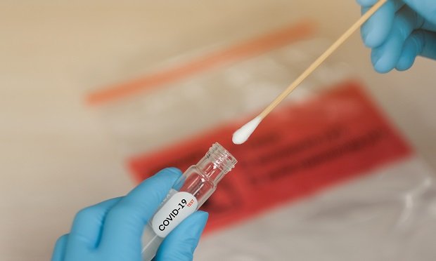 COVID swap being inserted into vial