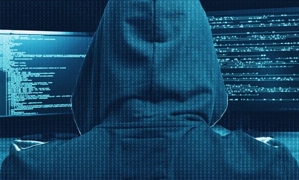 hacker carrying out a cyber attack at computer