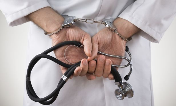 Doctor in handcuffs