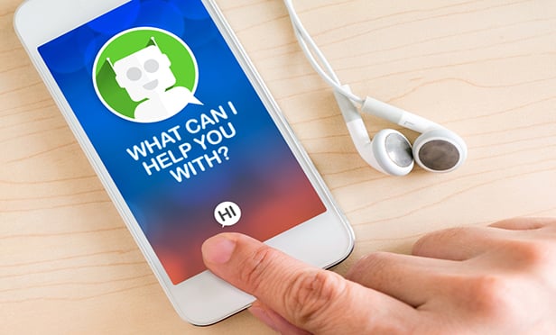 Smartphone with chatbot on screen and person's hand