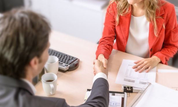 Insurance agent shaking hand of customer