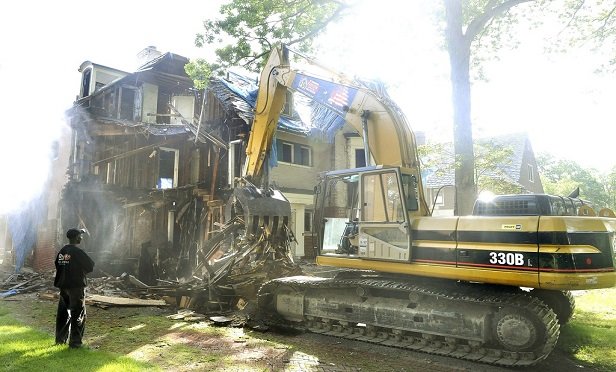 After a covered loss, demolition along with debris cleanup and removal should also be covered. (Photo: Daniel Mears/Detroit News/Newscom)