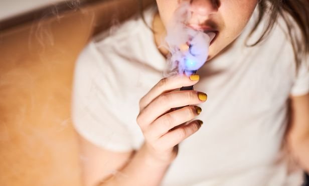 Woman smoking an e-cigarette.