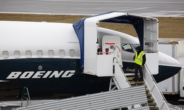 An employee stands next to a Boeing Co. 737 Max 9 plane at the company's manufacturing facility in Renton, Washington, U.S., on Tuesday, Mar. 12, 2019. (Photo : David Ryder/Bloomberg)