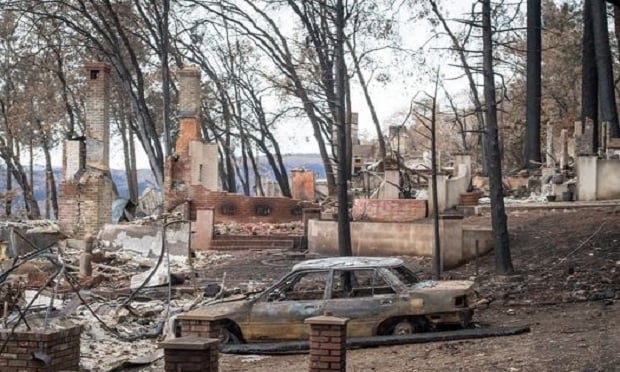 Burned-out homes and vehicles stand in Paradise, California, U.S., on Monday, November 26, 2018. The nation's deadliest wildfire in a century known as the Camp Fire that killed at least 85 people and burned over 14,000 homes has been fully contained after burning for more than two weeks, authorities said Sunday. Photographer: David Paul Morris