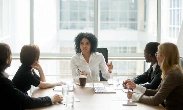 Black female boss leading business meeting