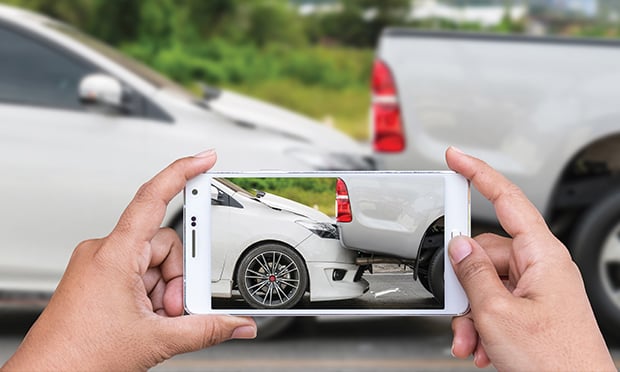 Person taking a photo of a rear-end accident.