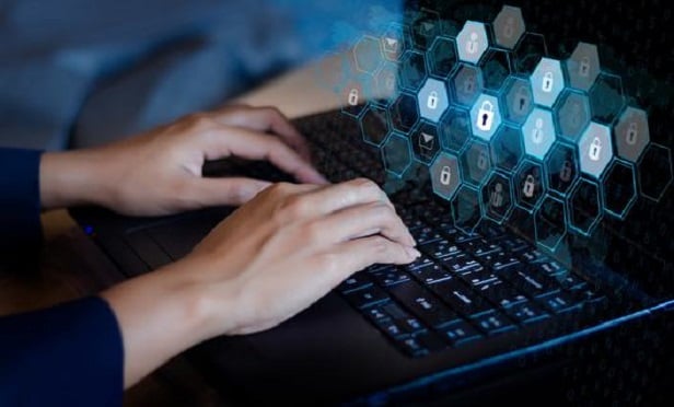 Man's hands on a computer keyboard.