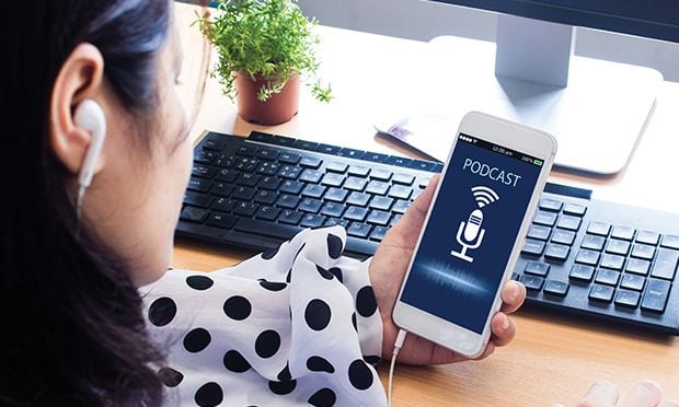 Woman listening to a podcast on her cell phone.