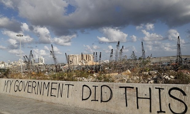 Words are written by Lebanese citizens in front of the scene of the August 4th explosion that hit the seaport of Beirut, Lebanon, Sunday, Aug. 9, 2020. Public fury over the massive explosion in Beirut took a new turn Saturday night as protesters stormed government institutions and clashed for hours with security forces, who responded with heavy volleys of tear gas and rubber bullets. (AP Photo/Hussein Malla)