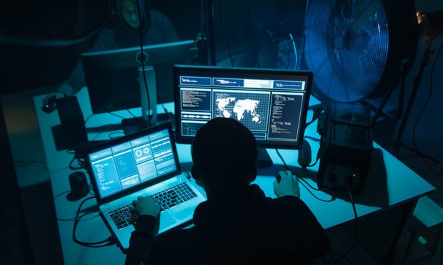 A hacker working in the dark.