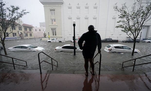 Floodwaters move on the street, Wednesday, Sept. 16, 2020, in Pensacola, Fla. Hurricane Sally made landfall Wednesday near Gulf Shores, Alabama, as a Category 2 storm, pushing a surge of ocean water onto the coast and dumping torrential rain that forecasters said would cause dangerous flooding from the Florida Panhandle to Mississippi and well inland in the days ahead.(AP Photo/Gerald Herbert)