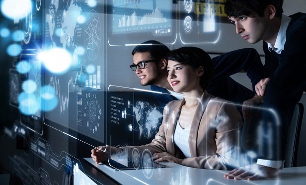 Innovators looking at technology screens.