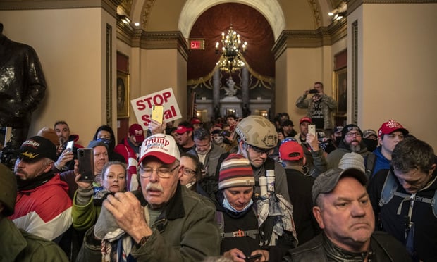 The fracas resulted in more than 50 arrests, four deaths and innumerable injuries as rioters left a trail of destruction throughout the seat of U.S. democracy. (Credit: Victor J. Blue/Bloomberg)