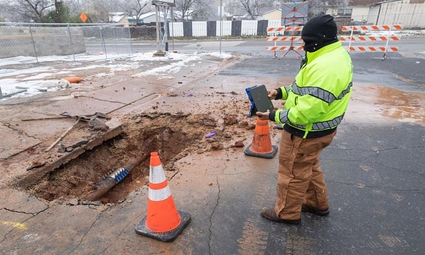 A City of Austin worker surveys a recently mended water pipe after it froze in Austin, Texas, on Feb. 18, 2021. (Photo: Thomas Ryan Allison/Bloomberg)
