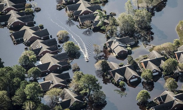 A boat passes through a flooded neighborhood in this aerial photograph taken above Wallace, North Carolina, U.S., on Friday, Sept. 21, 2018. (Photo: Alex Wroblewski/Bloomberg)
