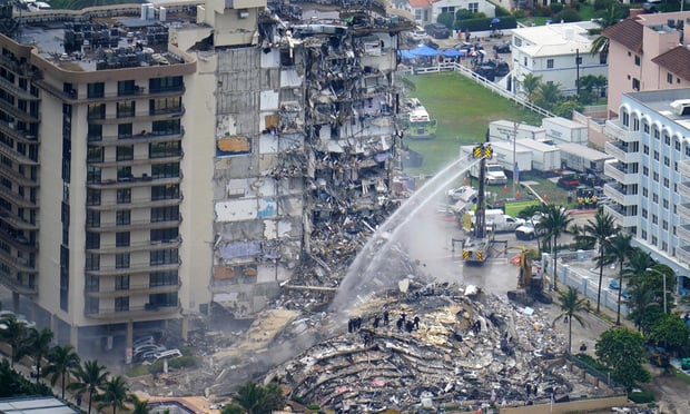 FILE - In this June 25, 2021, file photo, rescue personnel work at the remains of the Champlain Towers South condo building in Surfside, Fla. A judge says a mediator will be named to sort through claims arising from the collapse of a Florida condominium that killed 98 people. Miami-Dade Circuit Judge Michael Hanzman said at a hearing Wednesday, Oct. 6, 2021 that he is hoping to avoid a bitter and lengthy battle over money by victims. Photo: Gerald Herbert/AP