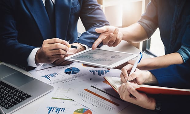 Business people reviewing charts and data.
