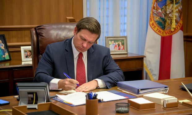 Photo of Florida Gov. Ron DeSantis signing documents