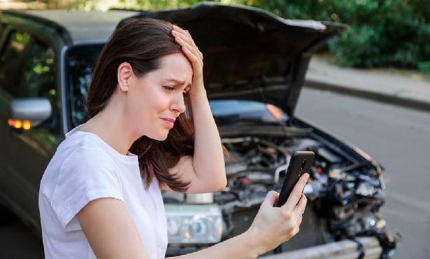 Woman on her cell phone after an auto accident.