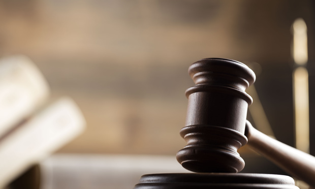 A photo of a gavel sitting on a desk.