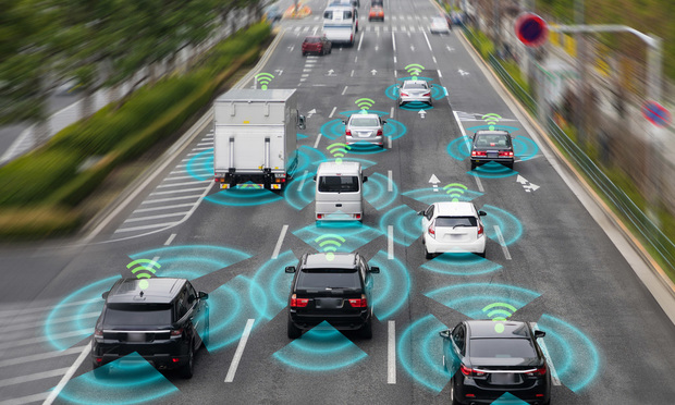 A simulation of vehicles with self-driving technology sensing each other as they travel down a road.