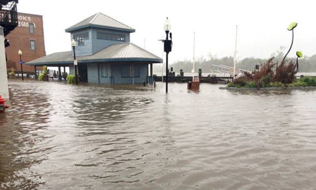 Wilmington North Carolina - USA / September 14, 2018. Downtown Wilmington begins to flood from storm surges. Visitor center on the foot of Market and Water St covered half way with flood waters.