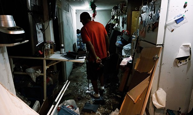 A New York City resident walks through his flooded basement level apartment in a Queens neighborhood that saw massive flooding and numerous deaths following a night of heavy wind and rain from the remnants of Hurricane Ida on September 03, 2021 in New York City. (Credit: Spencer Platt/Bloomberg)