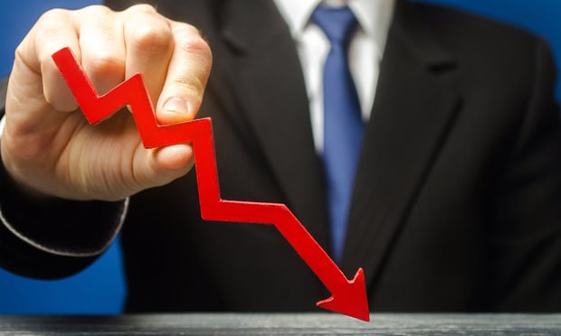 Businessman holds a red down arrow. The concept of reducing profits and income. Recession and the financial crisis. Capital outflow. Forecast. Credit