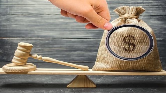 Scales of justice with money and a gavel.